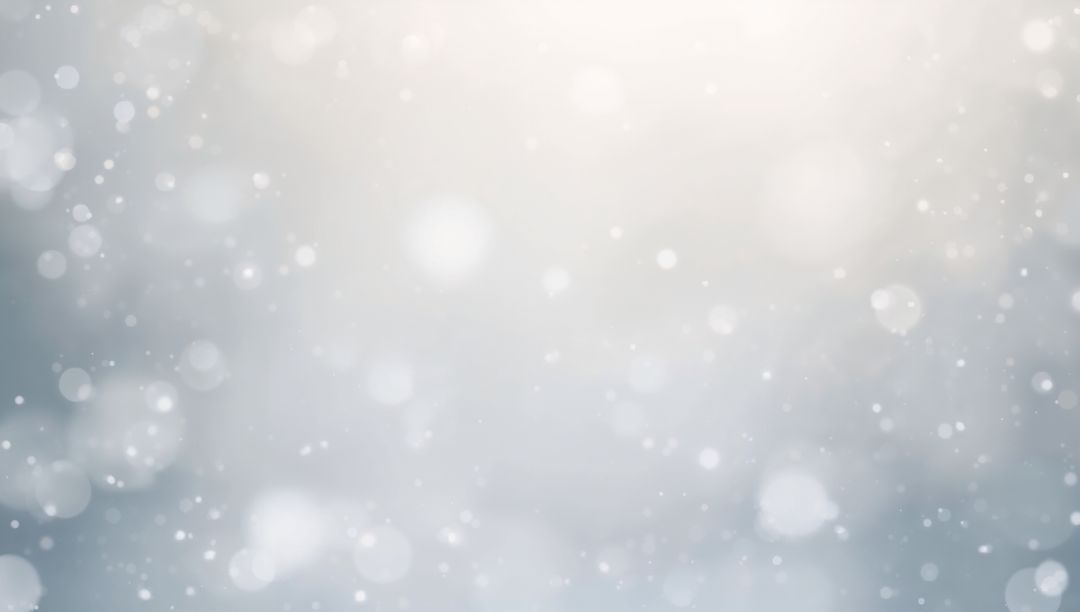 Falling Bokeh Orbs and Drifting Snow Creating Ethereal Soft Winter Light and Haze