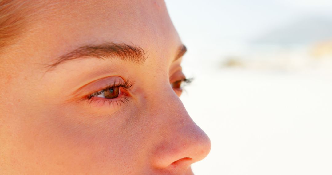 Close up of caucasian woman with brown eyes on beach - Free Images, Stock Photos and Pictures on Pikwizard.com