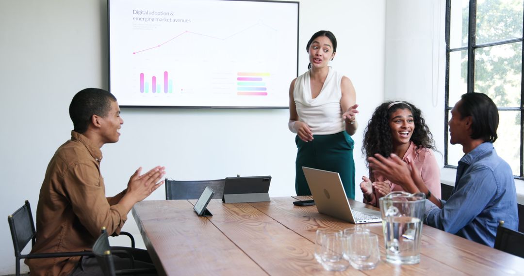 Diverse Team Celebrating Success in Modern Business Meeting