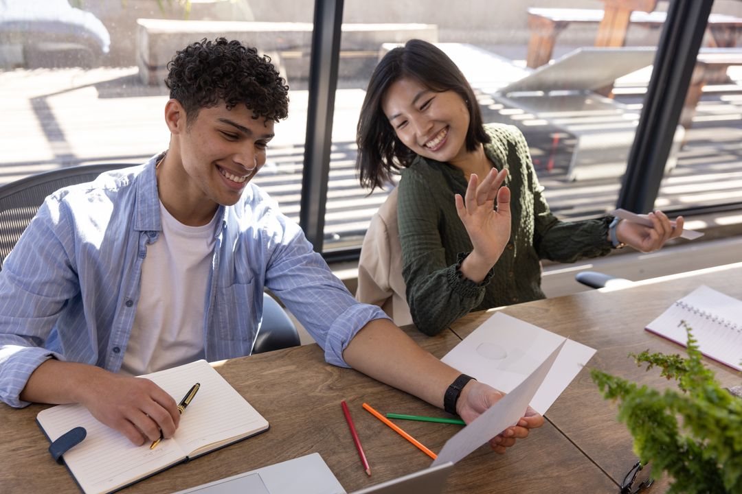 Diverse Office Team Analyzing Data Charts in Modern Workspace