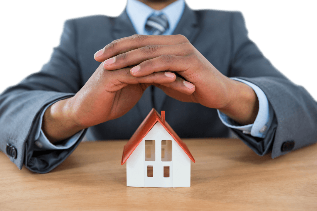 Businessman Protecting Transparent House Model with Hands
