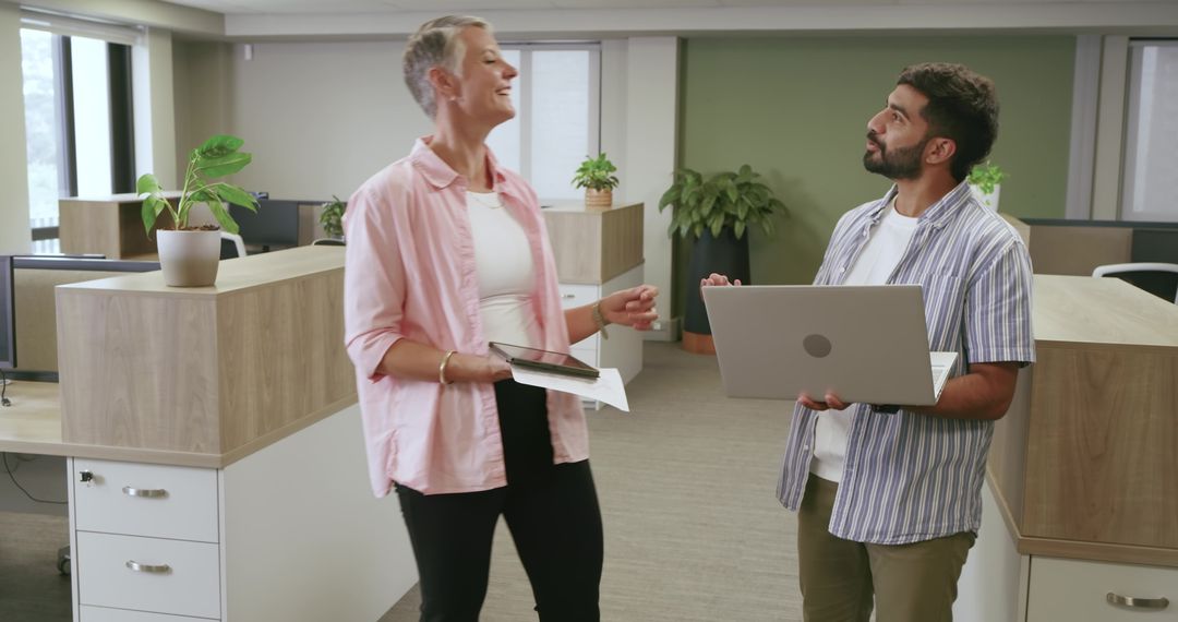 Diverse Coworkers Collaborating in Modern Open Office Environment
