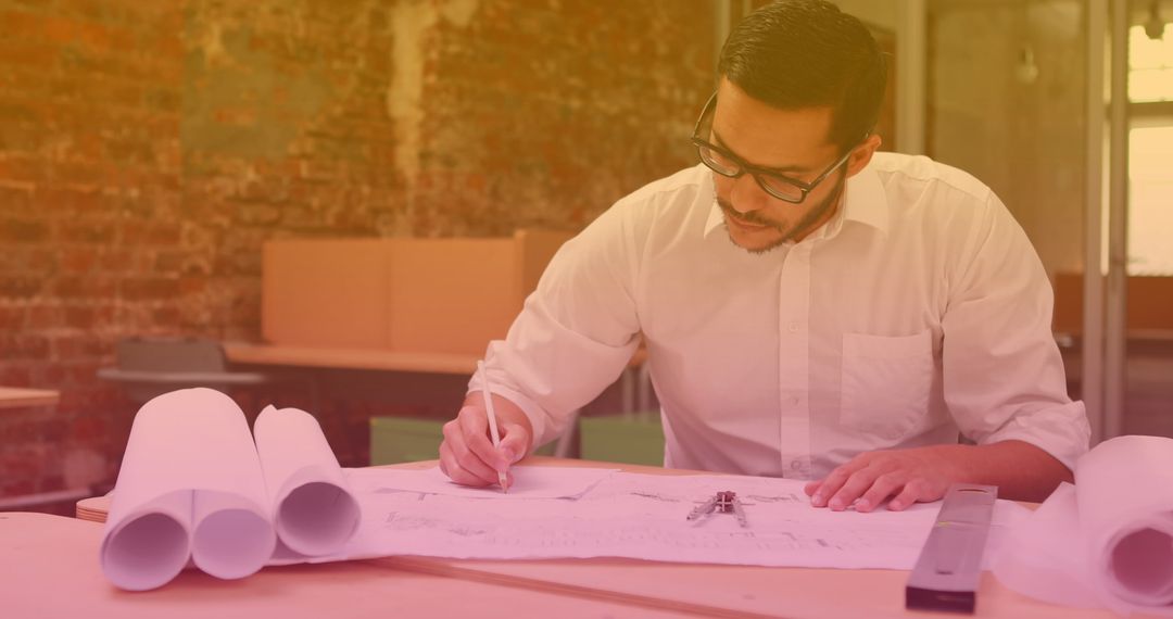 Architect Concentrating on Blueprint Design at Desk