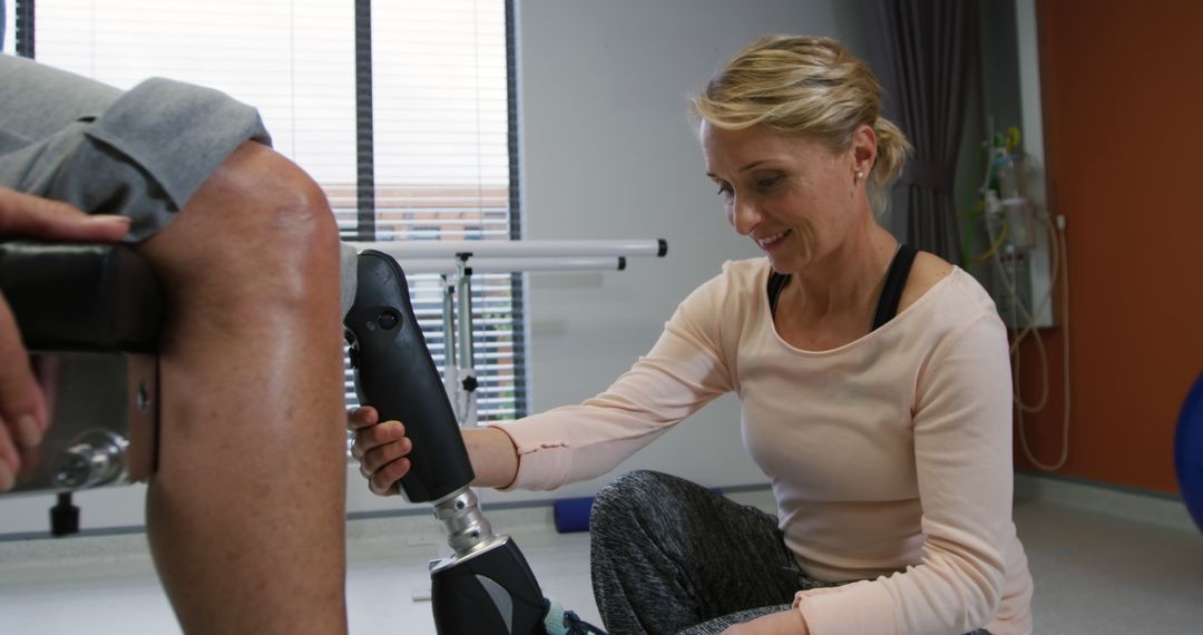 Therapist Helping Patient with Prosthetic Leg Fitting in Clinic - Free Images, Stock Photos and Pictures on Pikwizard.com