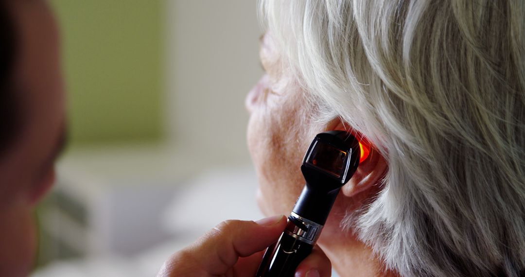 Senior Woman Undergoing Ear Examination by Doctor - Free Images, Stock Photos and Pictures on Pikwizard.com