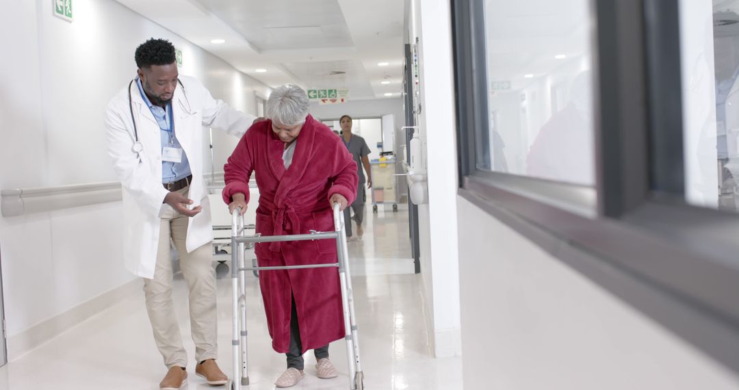 Doctor Assists Elderly Woman Using Walker in Hospital Corridor - Free Images, Stock Photos and Pictures on Pikwizard.com