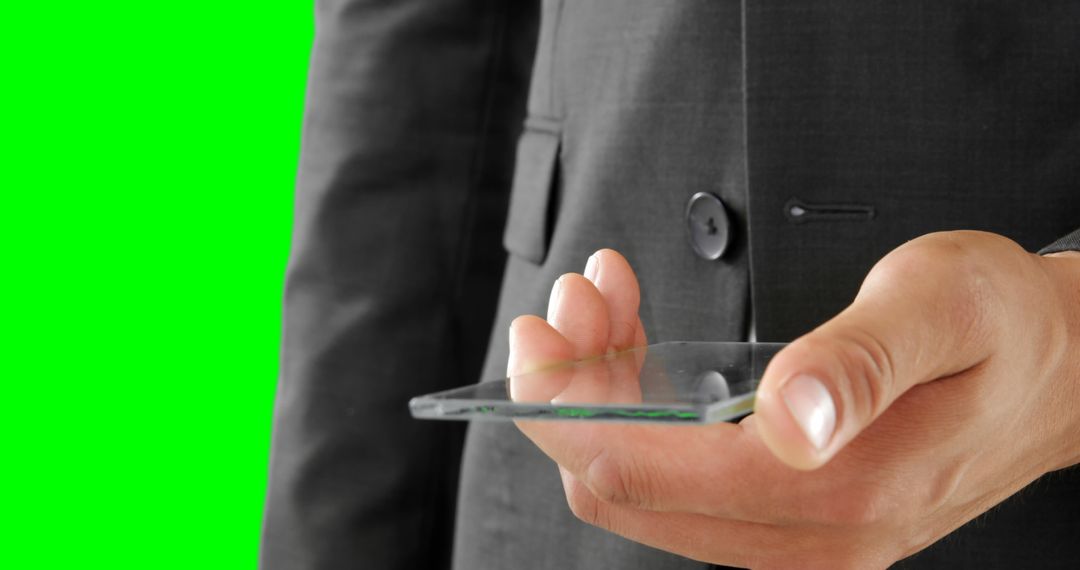 Businessman Holding Transparent Smartphone on Green Screen Background - Free Images, Stock Photos and Pictures on Pikwizard.com