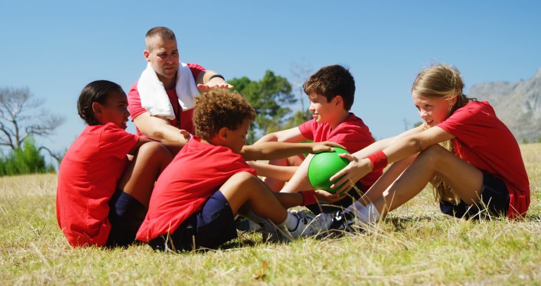 Coach Training Kids in Outdoor Team Exercise with Ball - Free Images, Stock Photos and Pictures on Pikwizard.com