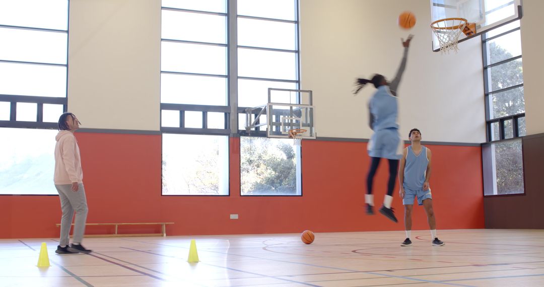 Team Basketball Practice With Coach Guiding Shooting Technique