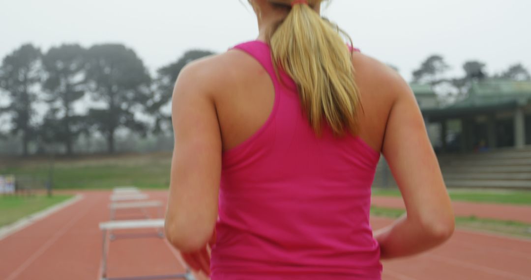 Female Athlete on a Running Track, Focused and Determined