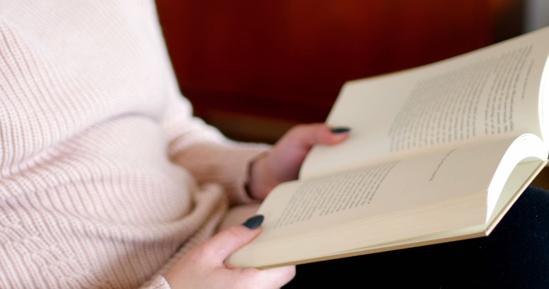 Person reading a book with soft light and warm setting - Free Images, Stock Photos and Pictures on Pikwizard.com