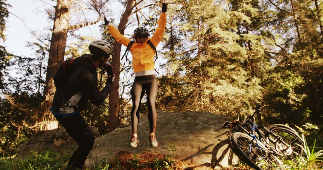 Joyful Cyclists Jumping on Forest Rock Trail - Free Images, Stock Photos and Pictures on Pikwizard.com