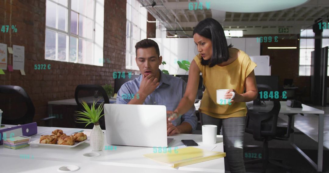 Professional Team Analyzing Data on Office Laptop in Modern Workspace