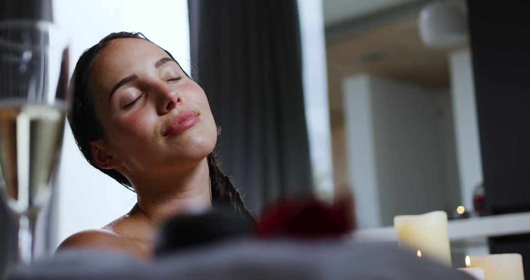 Relaxed Woman Enjoying Spa Time with Candles and Champagne - Free Images, Stock Photos and Pictures on Pikwizard.com