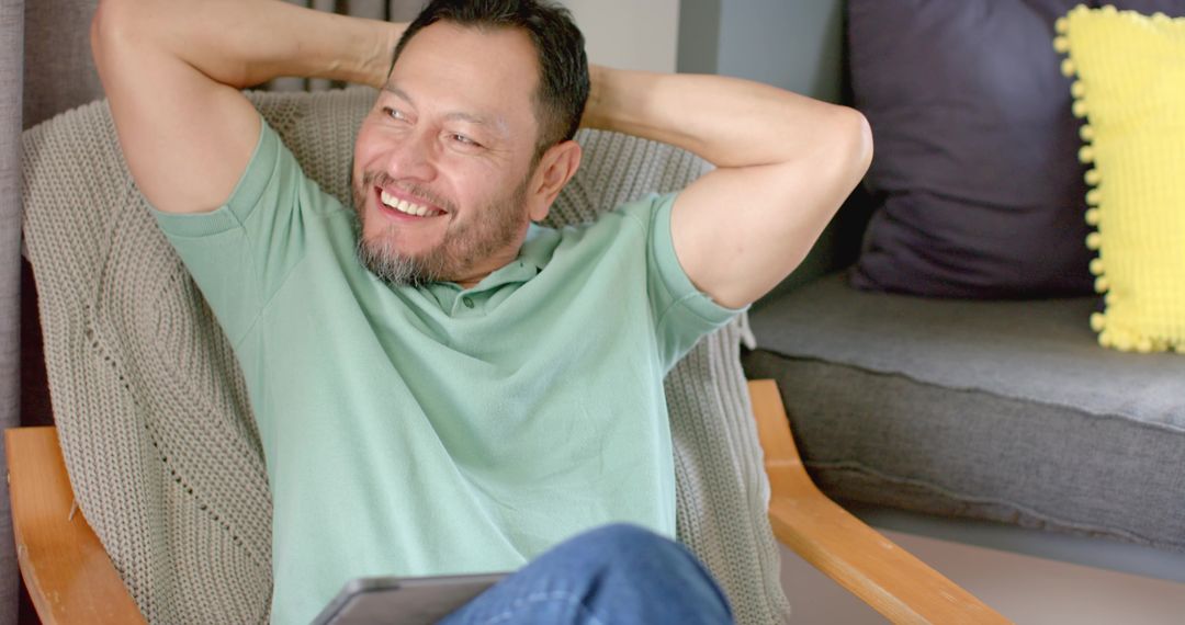 Elder Asian Man Relaxing at Home with Tablet