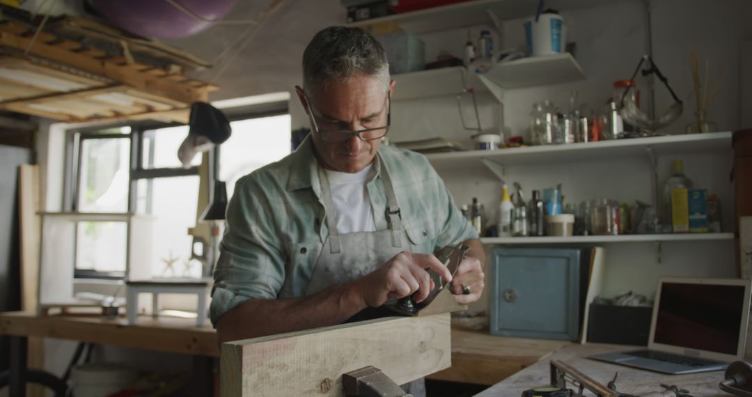 Man Engaged in Woodworking Project in Well-Equipped Workshop - Free Images, Stock Photos and Pictures on Pikwizard.com