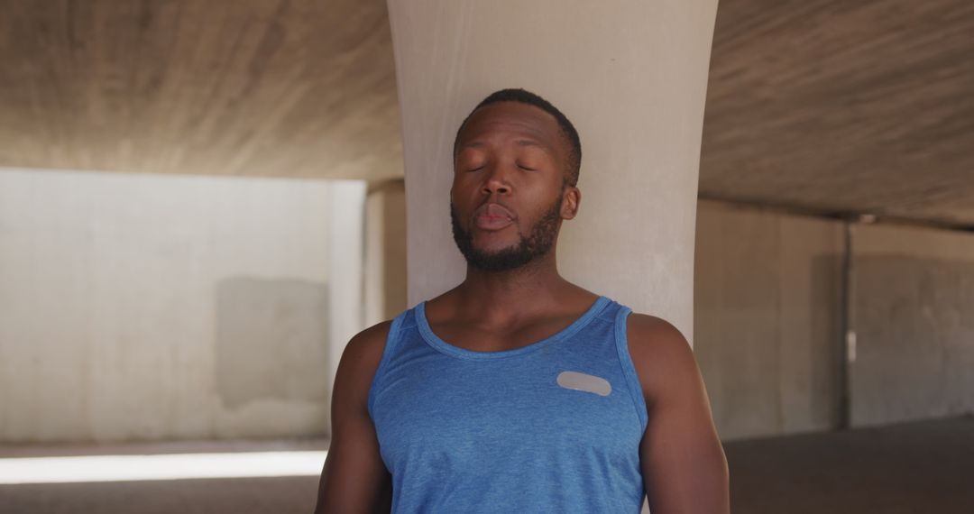 Young muscular African American man meditating under concrete structure - Free Images, Stock Photos and Pictures on Pikwizard.com