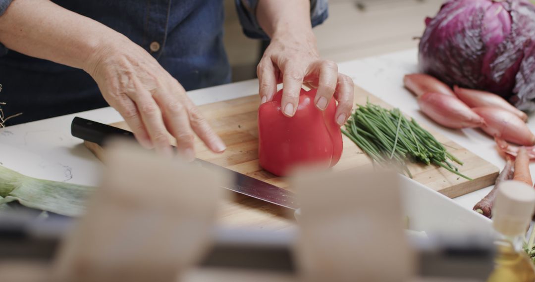 Senior Woman Prepping Vegetables in Bright Kitchen Scene - Free Images, Stock Photos and Pictures on Pikwizard.com