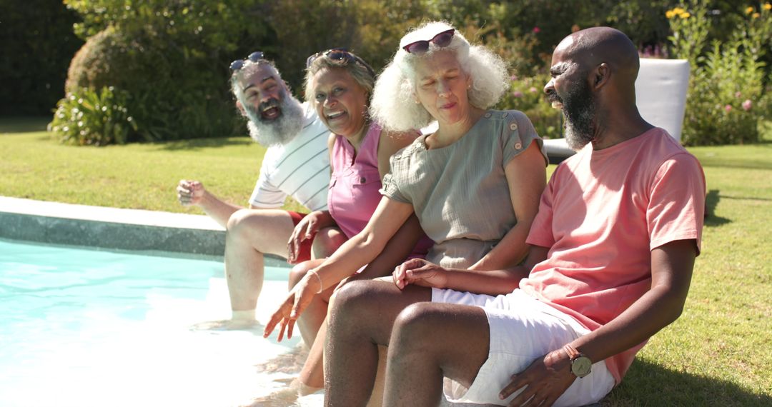 Senior Friends Enjoying Sunny Day by Poolside