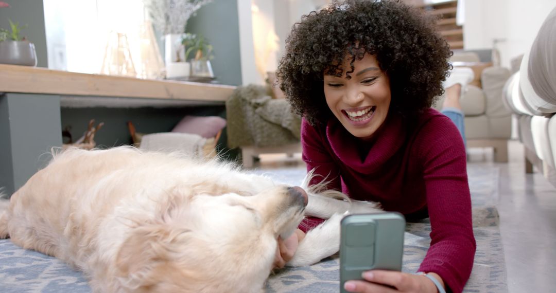 Smiling woman lying on floor taking selfie with dog in cozy home - Free Images, Stock Photos and Pictures on Pikwizard.com