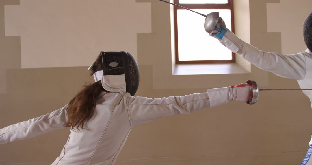 Female Athletes Fencing in Indoor Sports Facility - Free Images, Stock Photos and Pictures on Pikwizard.com