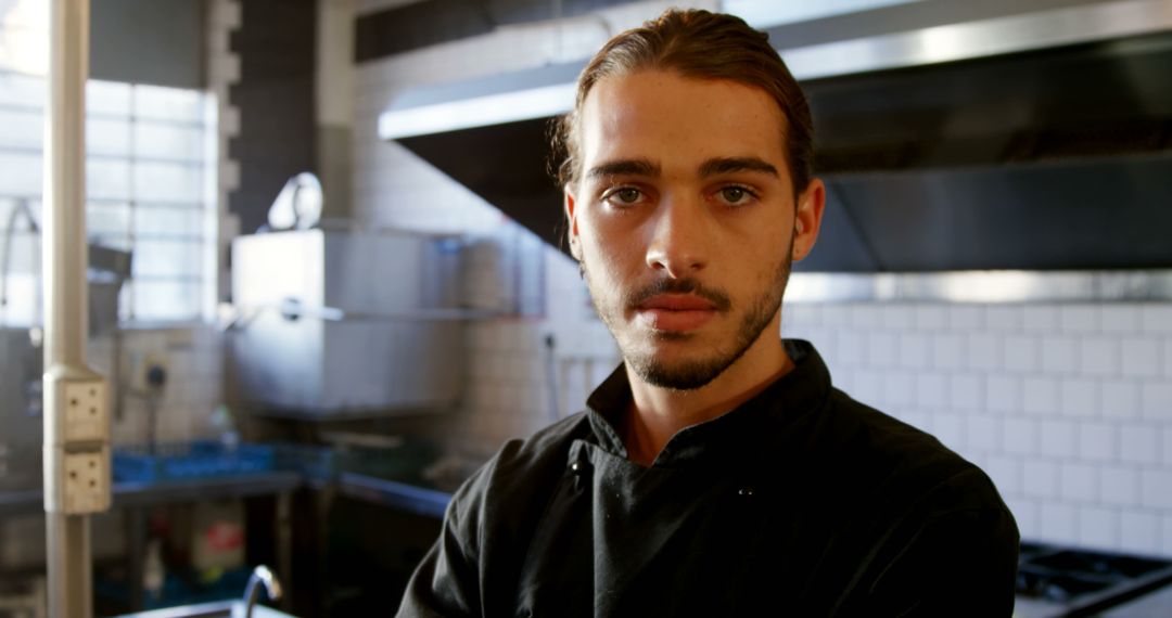 Confident Young Chef Posing in Professional Kitchen - Free Images, Stock Photos and Pictures on Pikwizard.com