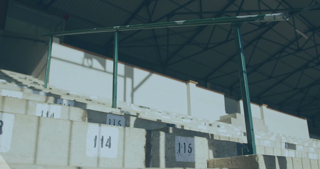 Empty Stadium Seats in Sunlight with Numbered Rows