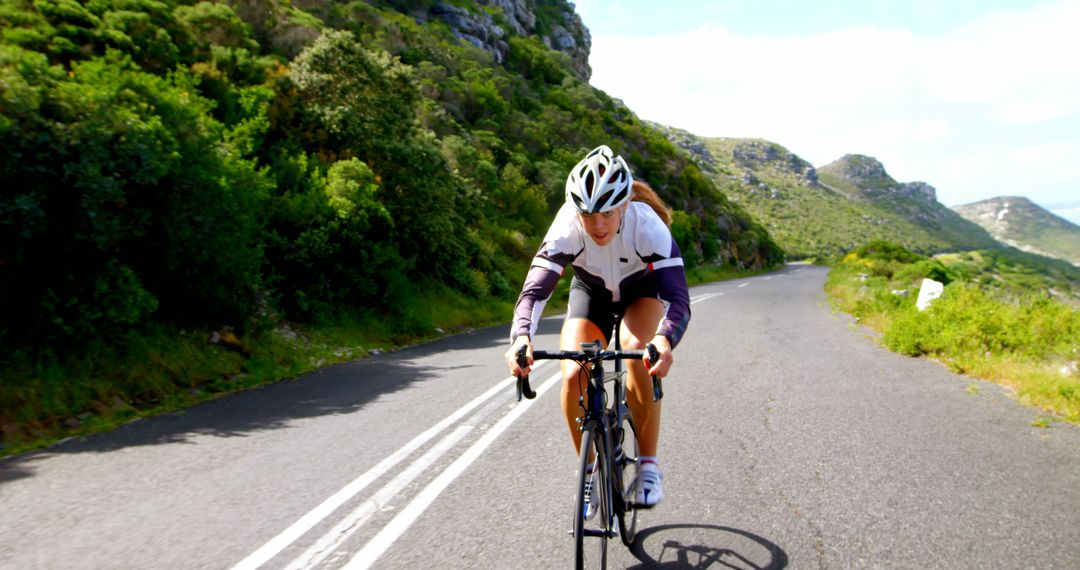 Female Cyclist Riding on Mountain Road - Free Images, Stock Photos and Pictures on Pikwizard.com