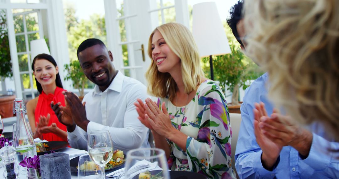 Diverse Group Celebrating Joyful Event at Dining Table