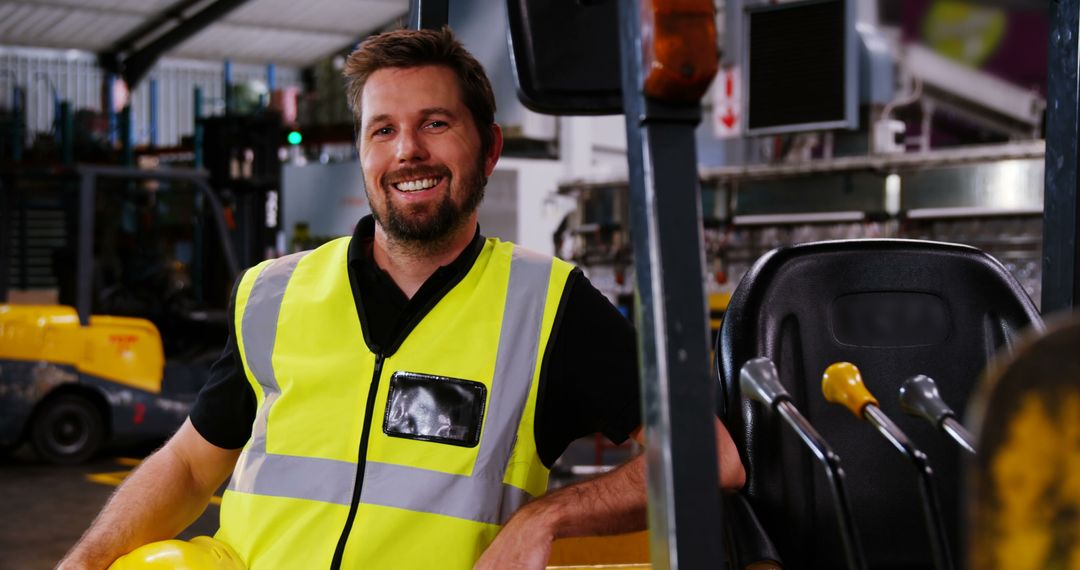 Engineer Wearing High Visibility Vest Smiling in Factory - Free Images, Stock Photos and Pictures on Pikwizard.com