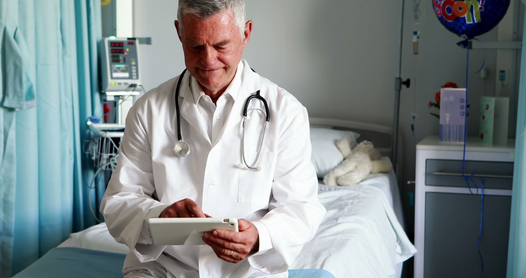 Senior Doctor Using Digital Tablet in Hospital Room - Free Images, Stock Photos and Pictures on Pikwizard.com