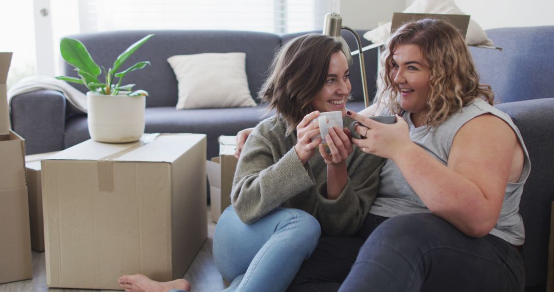 Happy Lesbian Couple Enjoying Tea and Moving Day