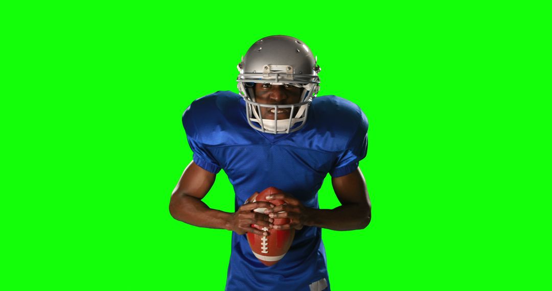 American Football Player Posing with Ball in Blue Uniform on Green Screen - Free Images, Stock Photos and Pictures on Pikwizard.com