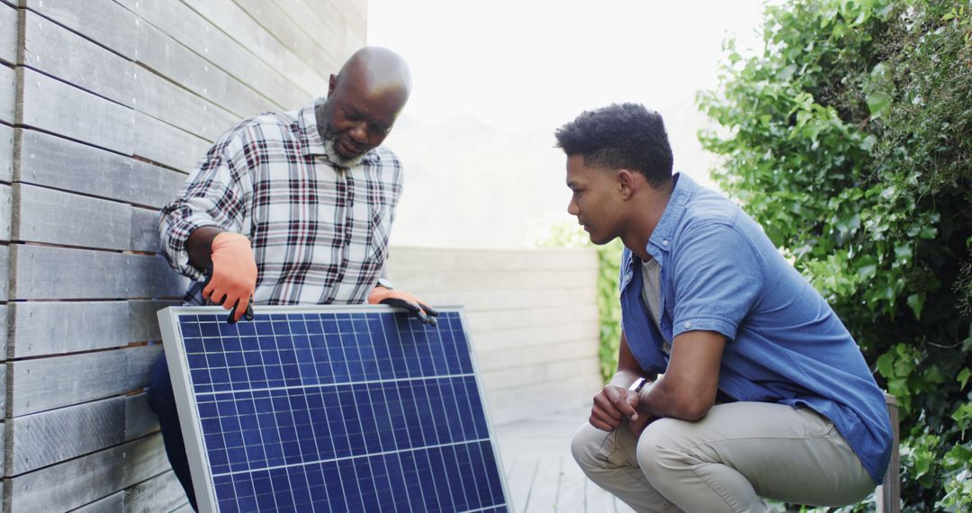 Two Diverse Men Installing Solar Panel on Building Exterior - Free Images, Stock Photos and Pictures on Pikwizard.com