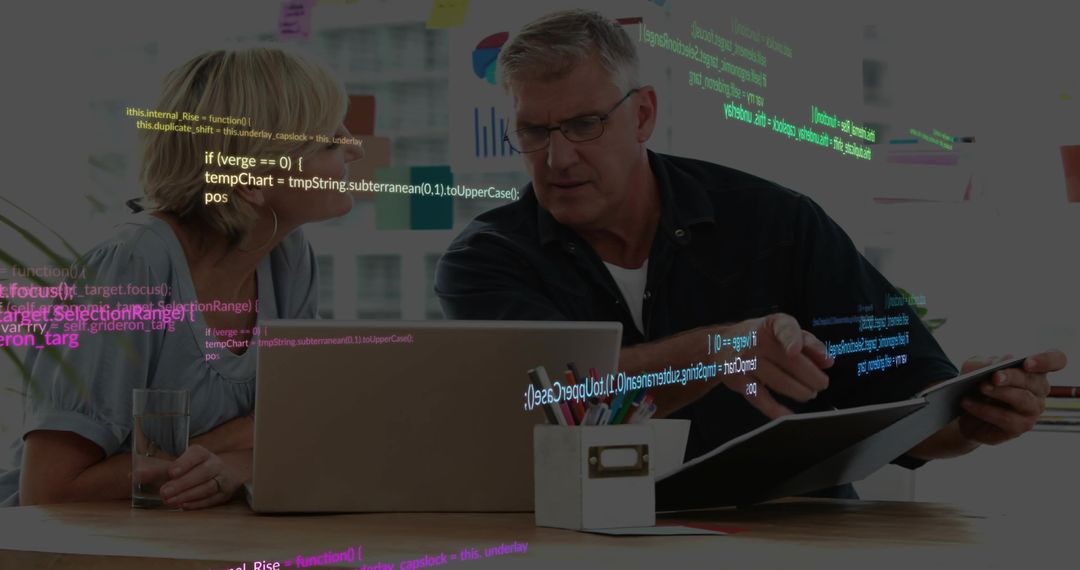 Business-Casual Team Collaborating on Software Code Review with Laptop and Binder