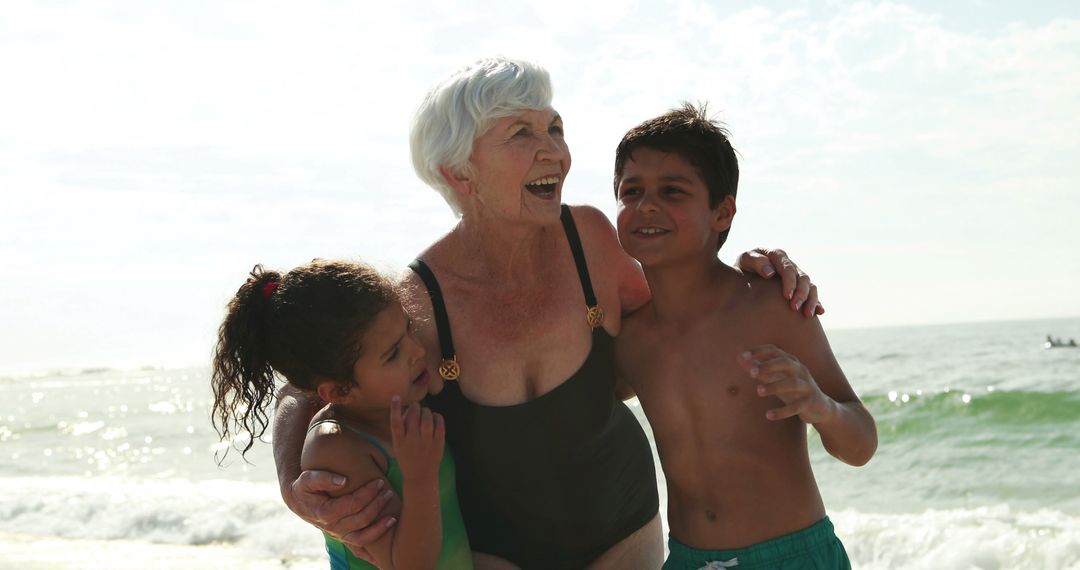 Grandmother Hugging Grandchildren at the Beach - Free Images, Stock Photos and Pictures on Pikwizard.com