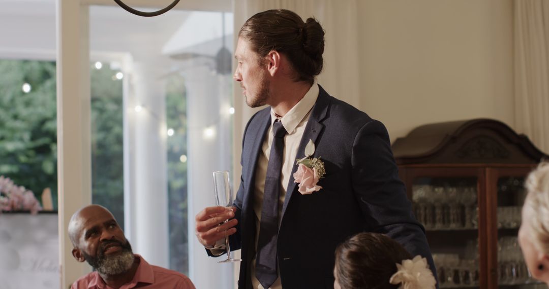 Groom giving toast in elegant wedding reception celebration