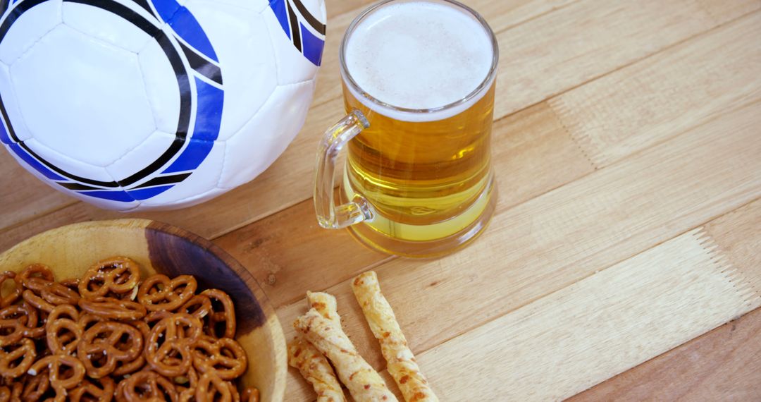 Soccer Ball and Beer with Snacks on Wooden Table - Free Images, Stock Photos and Pictures on Pikwizard.com