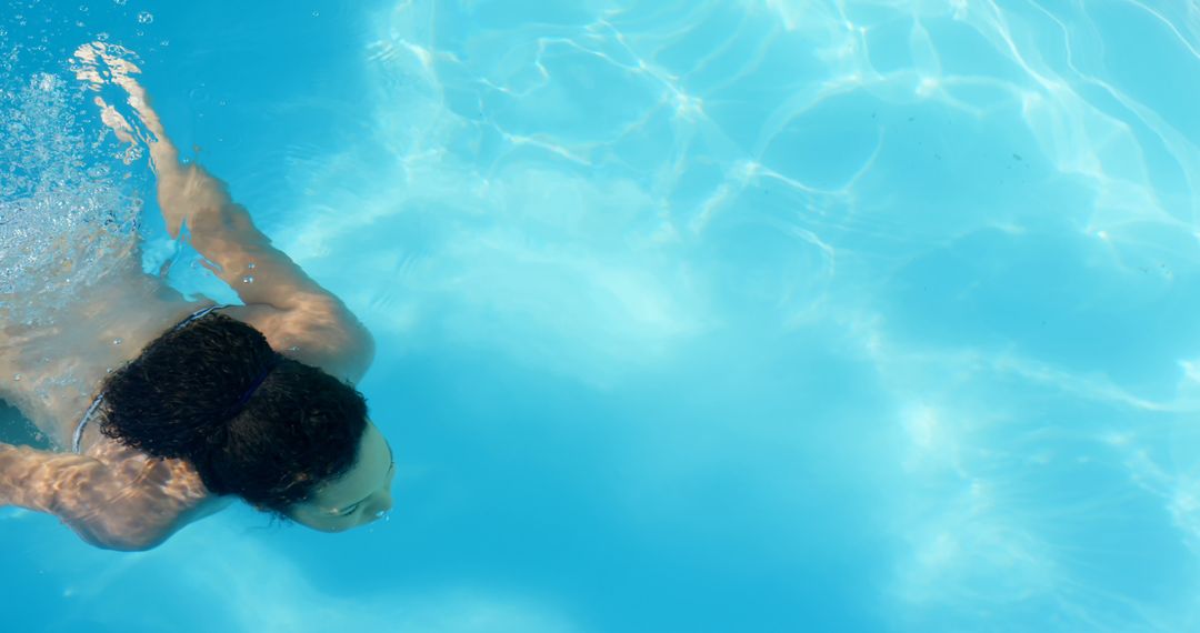 Young Woman Swimming Underwater in Clear Blue Pool - Free Images, Stock Photos and Pictures on Pikwizard.com