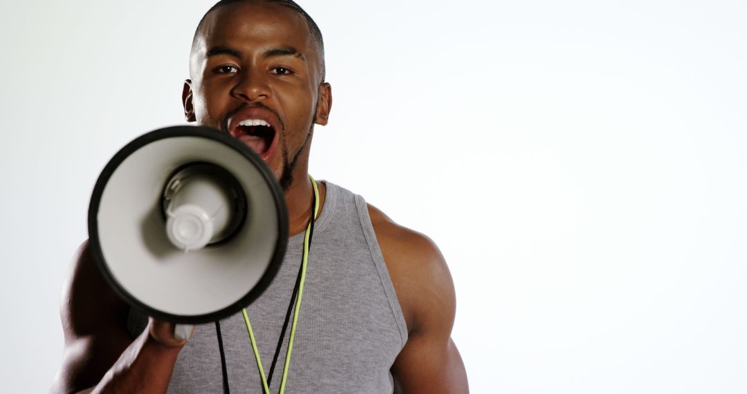 An African American man is energetically speaking into a megaphone, with copy space - Free Images, Stock Photos and Pictures on Pikwizard.com