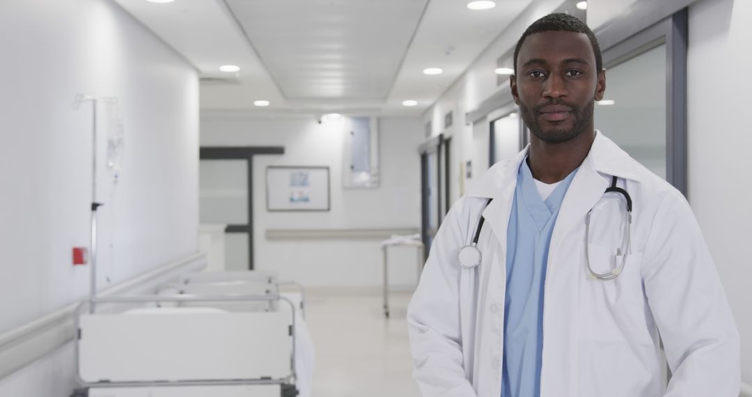 Confident African American Male Doctor in Modern Hospital Corridor - Free Images, Stock Photos and Pictures on Pikwizard.com