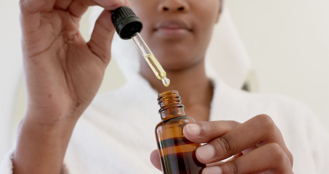 Woman Applying Serum with Dropper Bottle for Skincare Routine - Free Images, Stock Photos and Pictures on Pikwizard.com