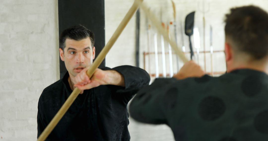 Two Martial Artists Practicing Bo Staff Techniques - Free Images, Stock Photos and Pictures on Pikwizard.com