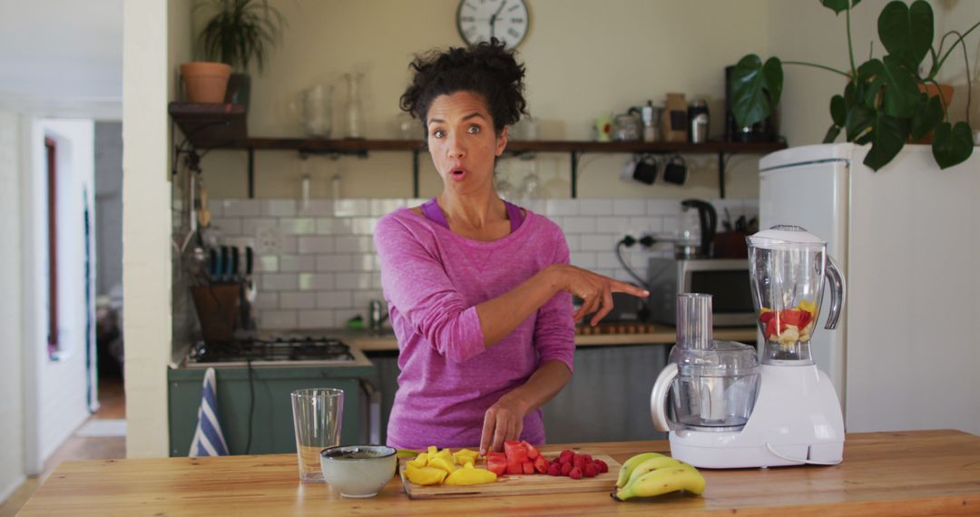 Woman Pointing at Blender While Preparing Healthy Fruit Smoothie in Modern Kitchen - Free Images, Stock Photos and Pictures on Pikwizard.com