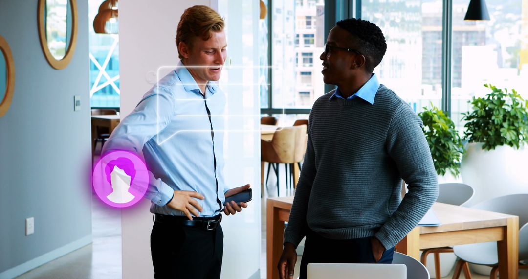 Diverse Colleagues Engaging in Office Conversation Near Laptop