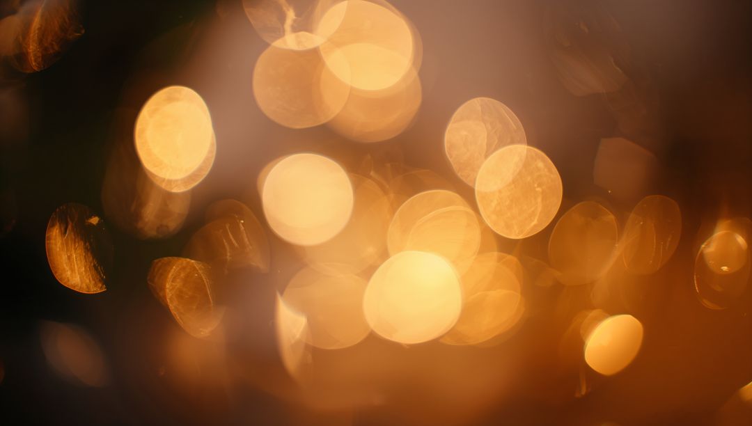Warm Golden Bokeh Lights Abstract Background with Soft Glowing Orbs and Lens Flare