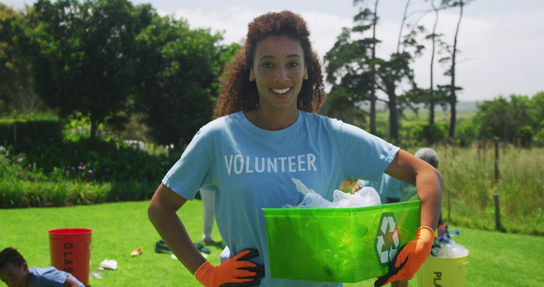 Female volunteer collecting recyclables in green environment - Free Images, Stock Photos and Pictures on Pikwizard.com