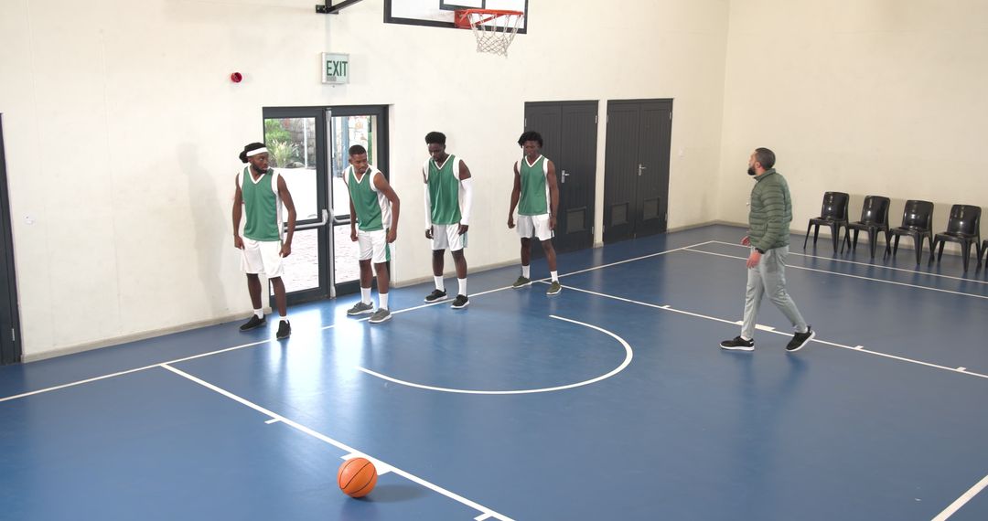 Diverse Basketball Team Practicing Skills on Indoor Court