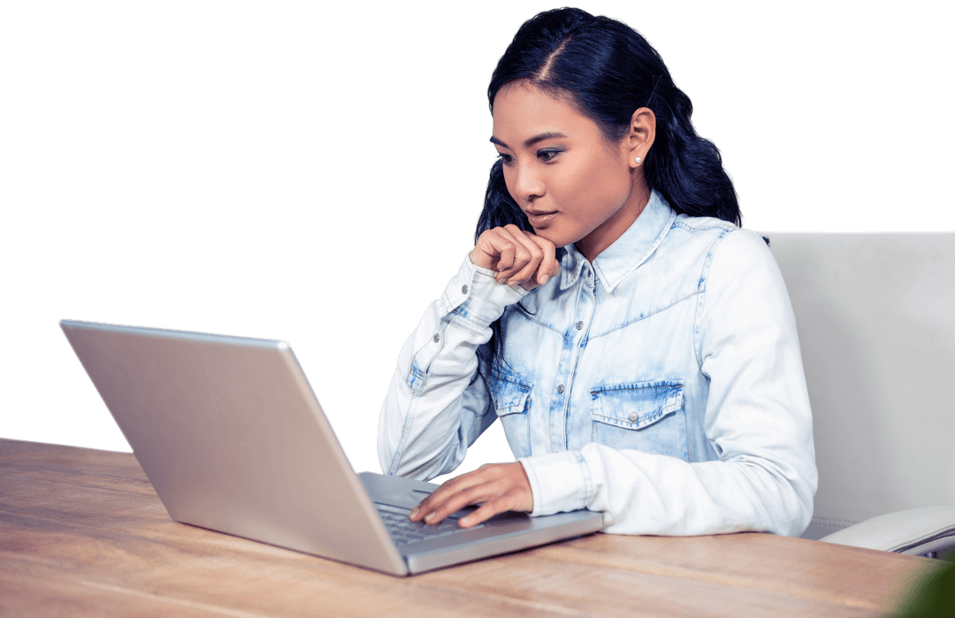 Focused Asian Woman Working on Laptop at Transparent Desk