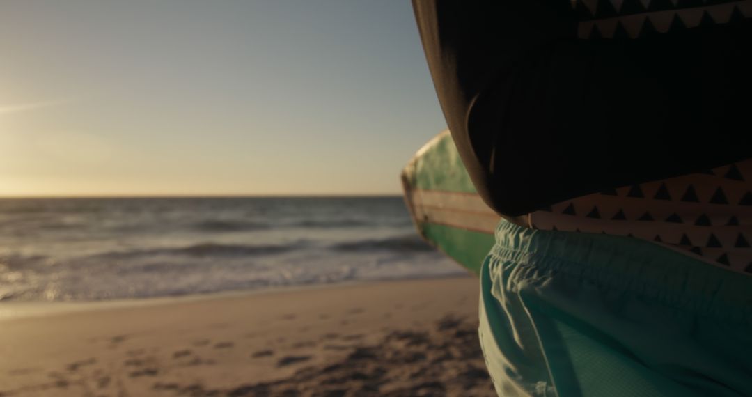 Person Standing on Beach Holding Surfboard at Sunset - Free Images, Stock Photos and Pictures on Pikwizard.com